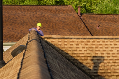 Home inspector examines architectural, asphalt shingled roof